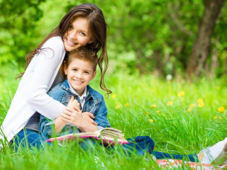 Mother and son with a book sitting in the New Forest Ringwood Family Photography