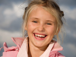 Happy smiling young girl in park